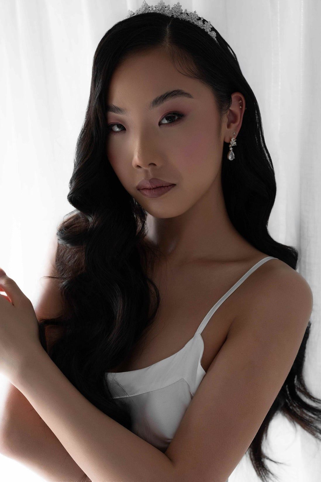 Model wearing bridal slip and silver bridal tiara