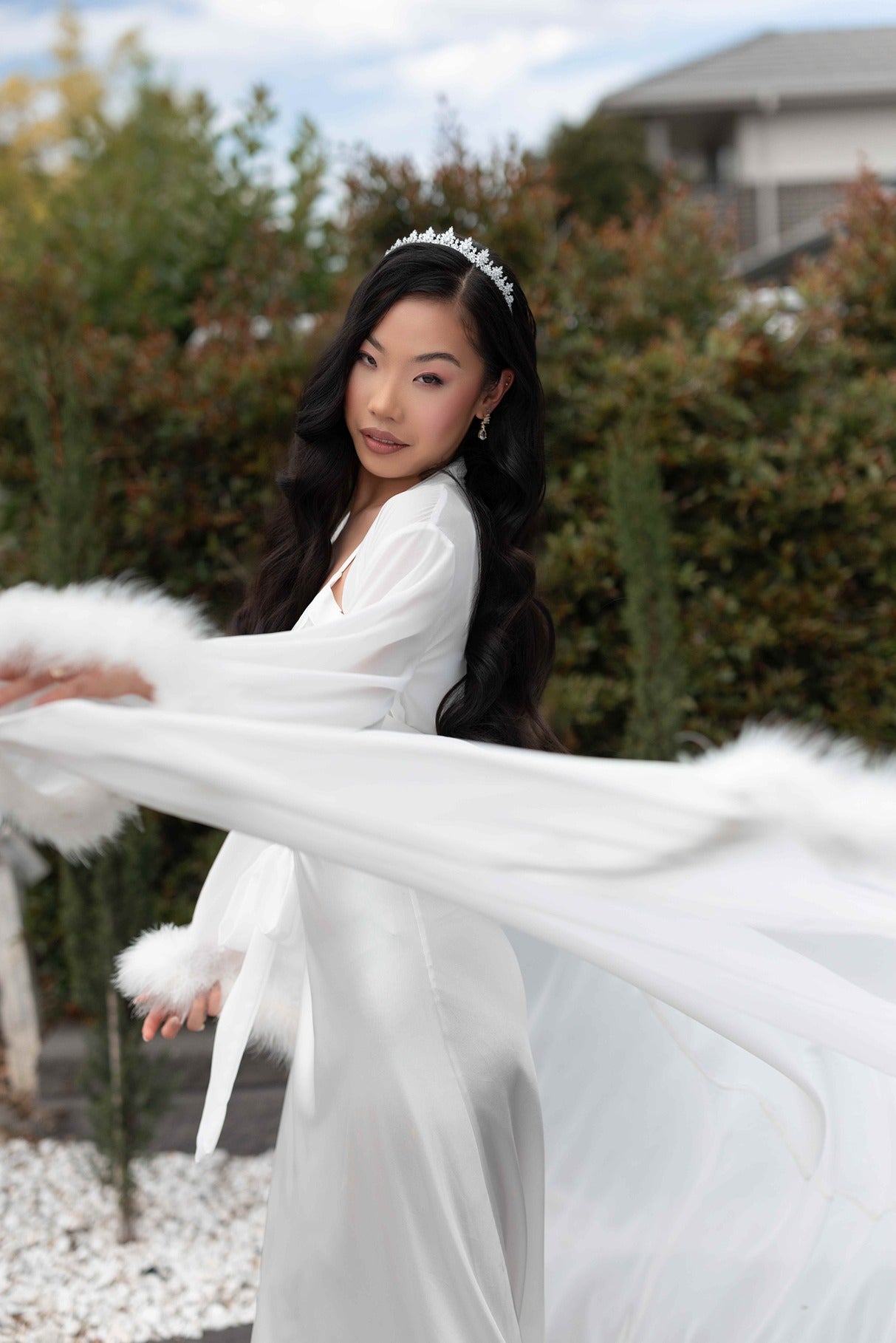 Model wearing fluffy bridal robe and silver bridal tiara