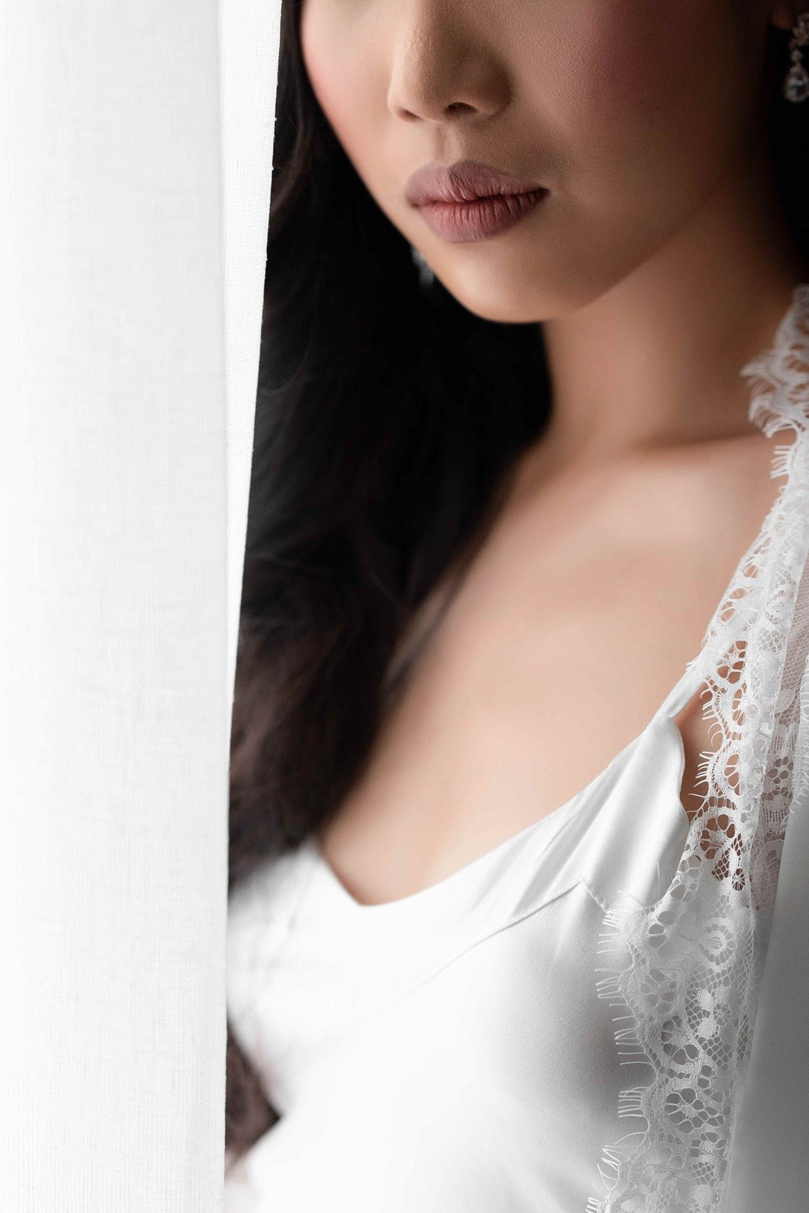 Bride wearing lace trim bridal robe close up shot on lace details