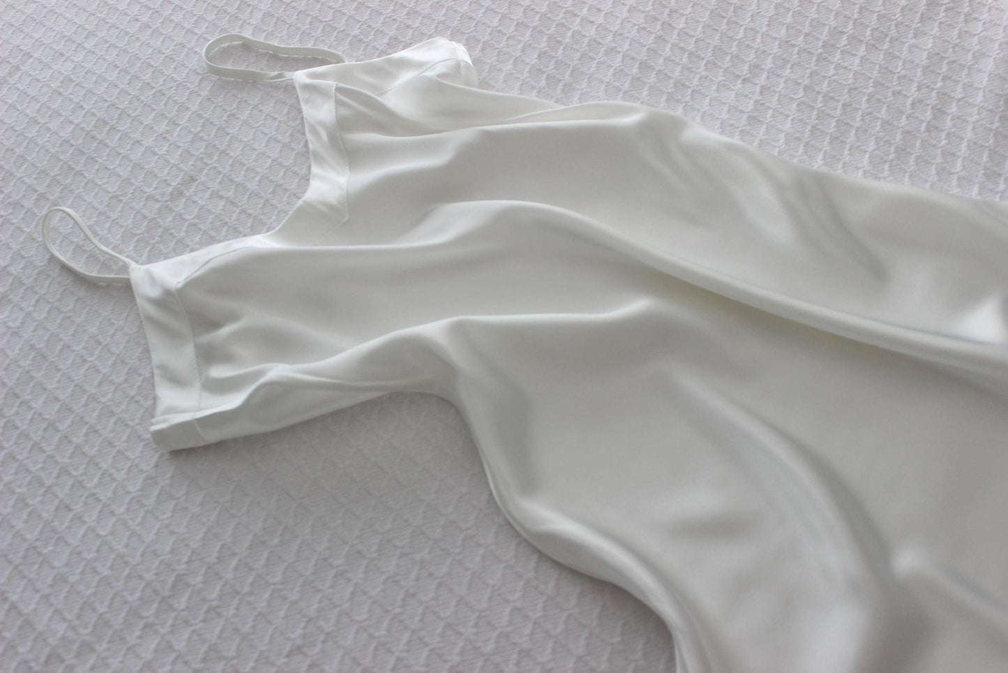 Satin Bridal Slip Laid Out On Bed