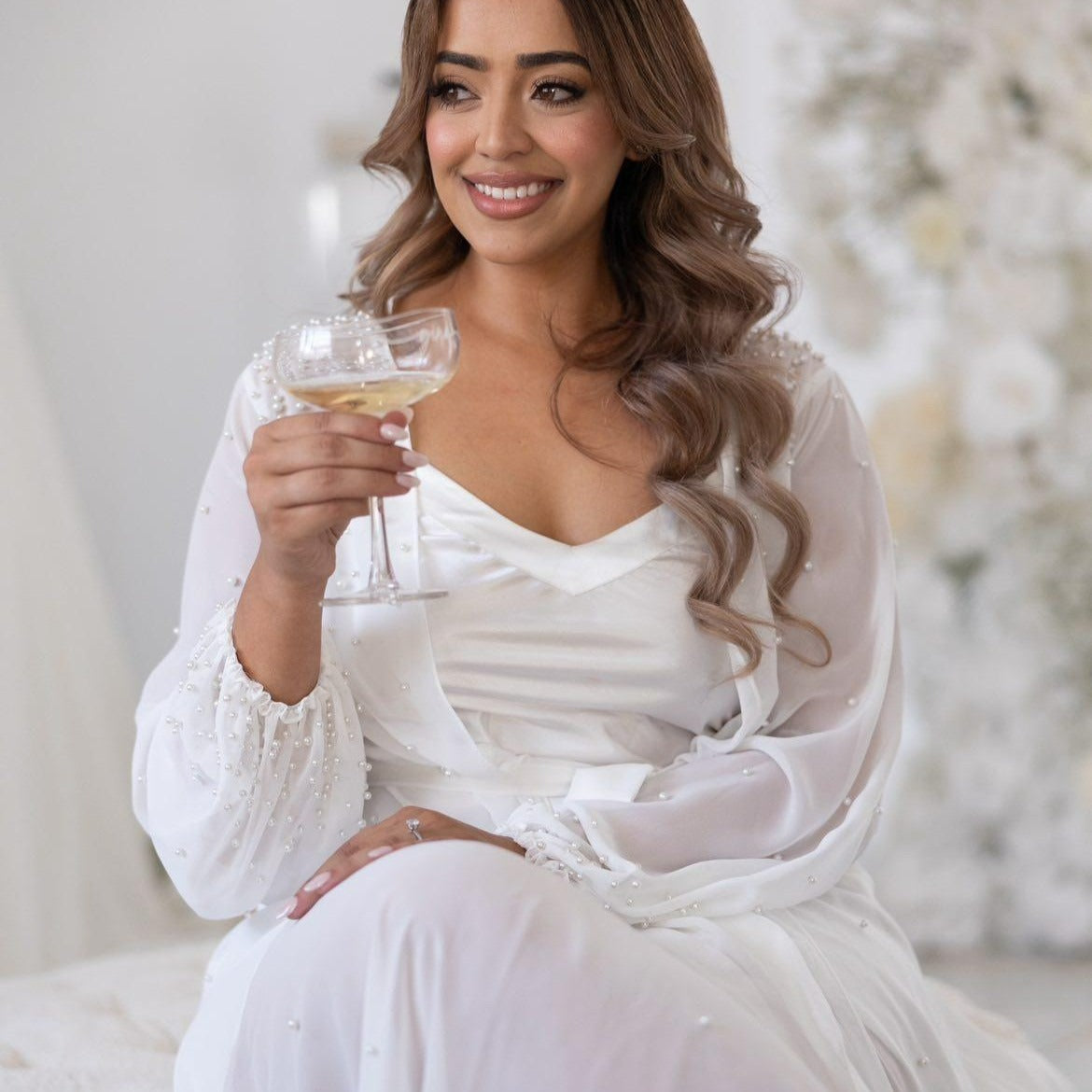 Bride wearing pearl bridal robe and bridal slip