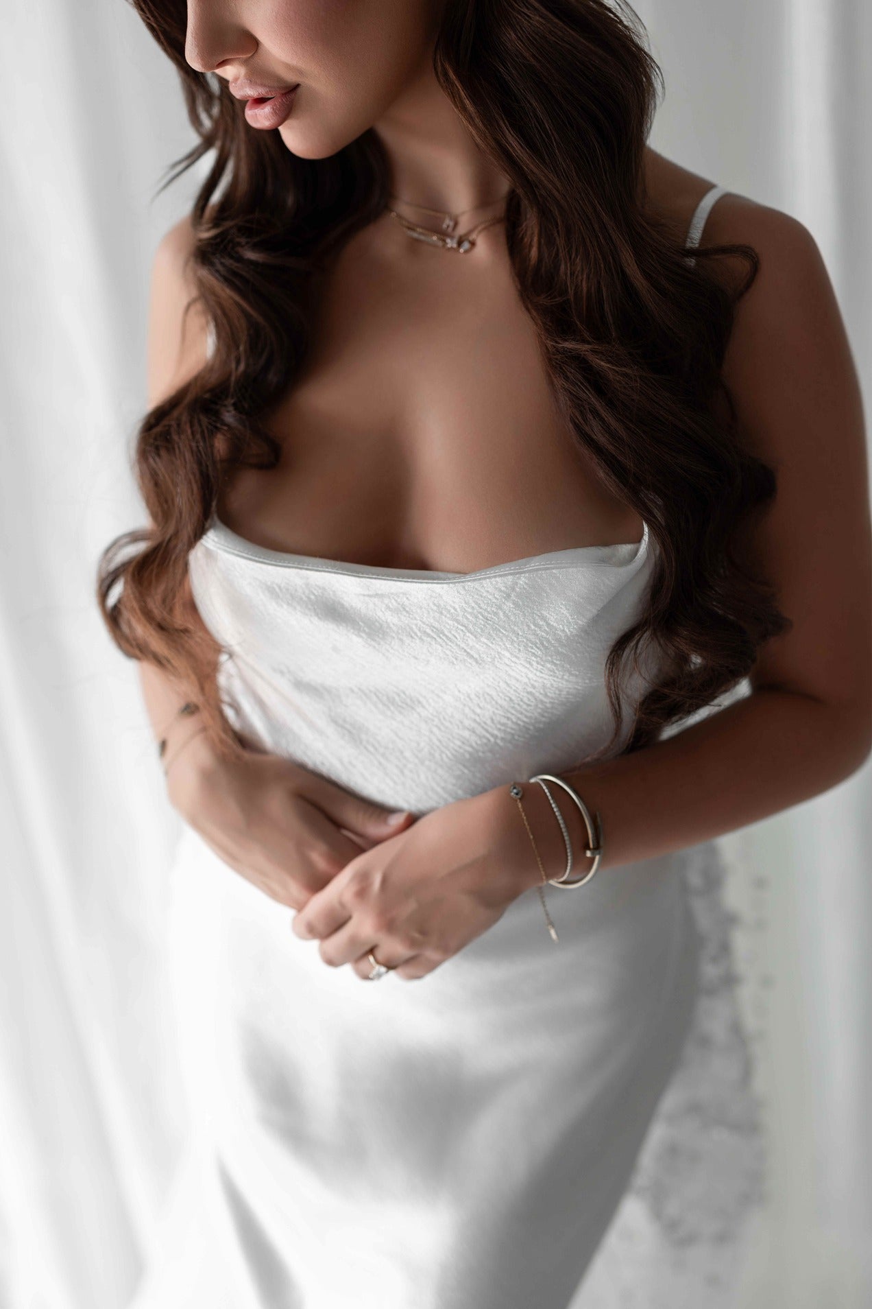 Woman wearing a white bridal slip dress with a blurred background