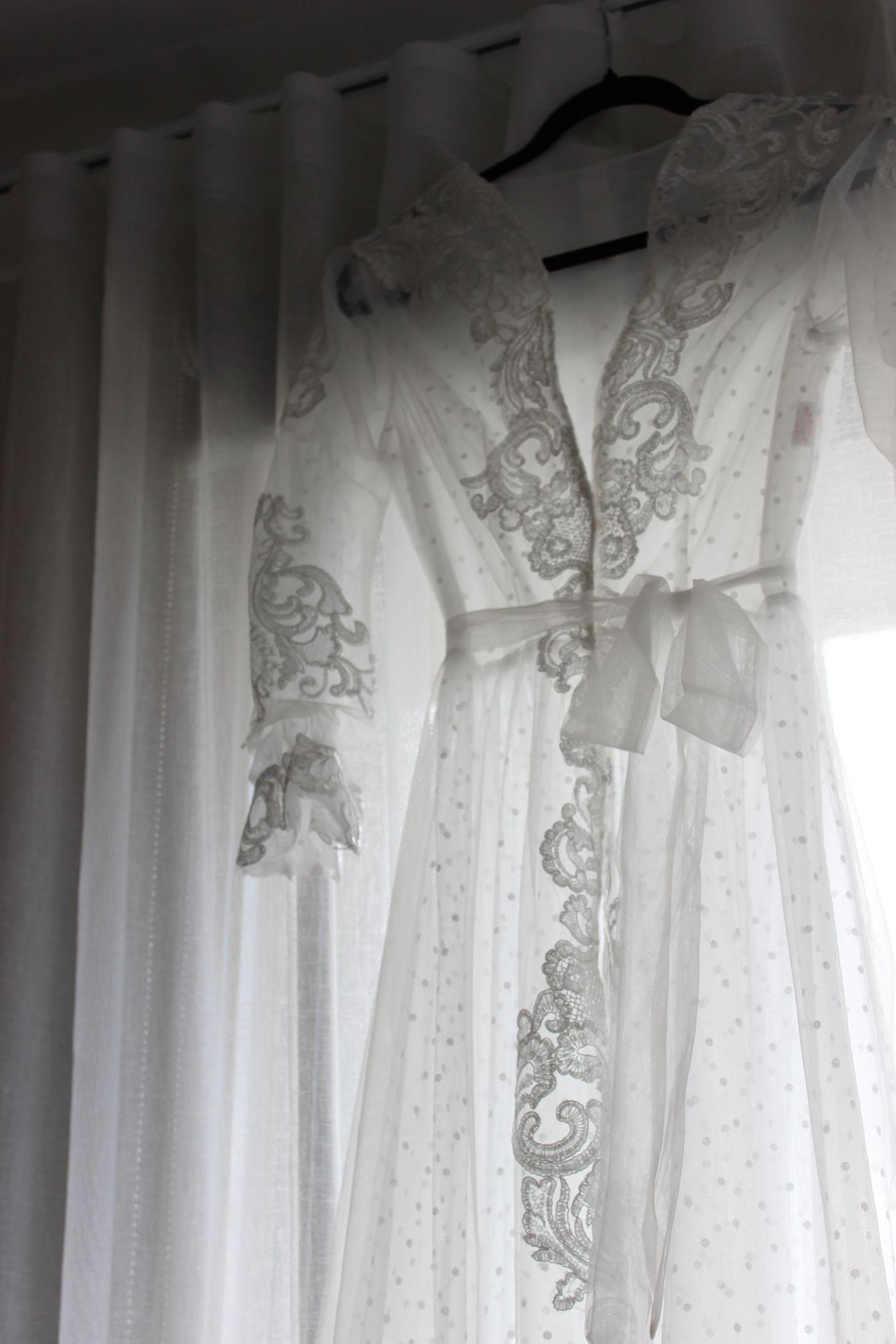 Close up of the Ariana Lace Robe on black coat hanger