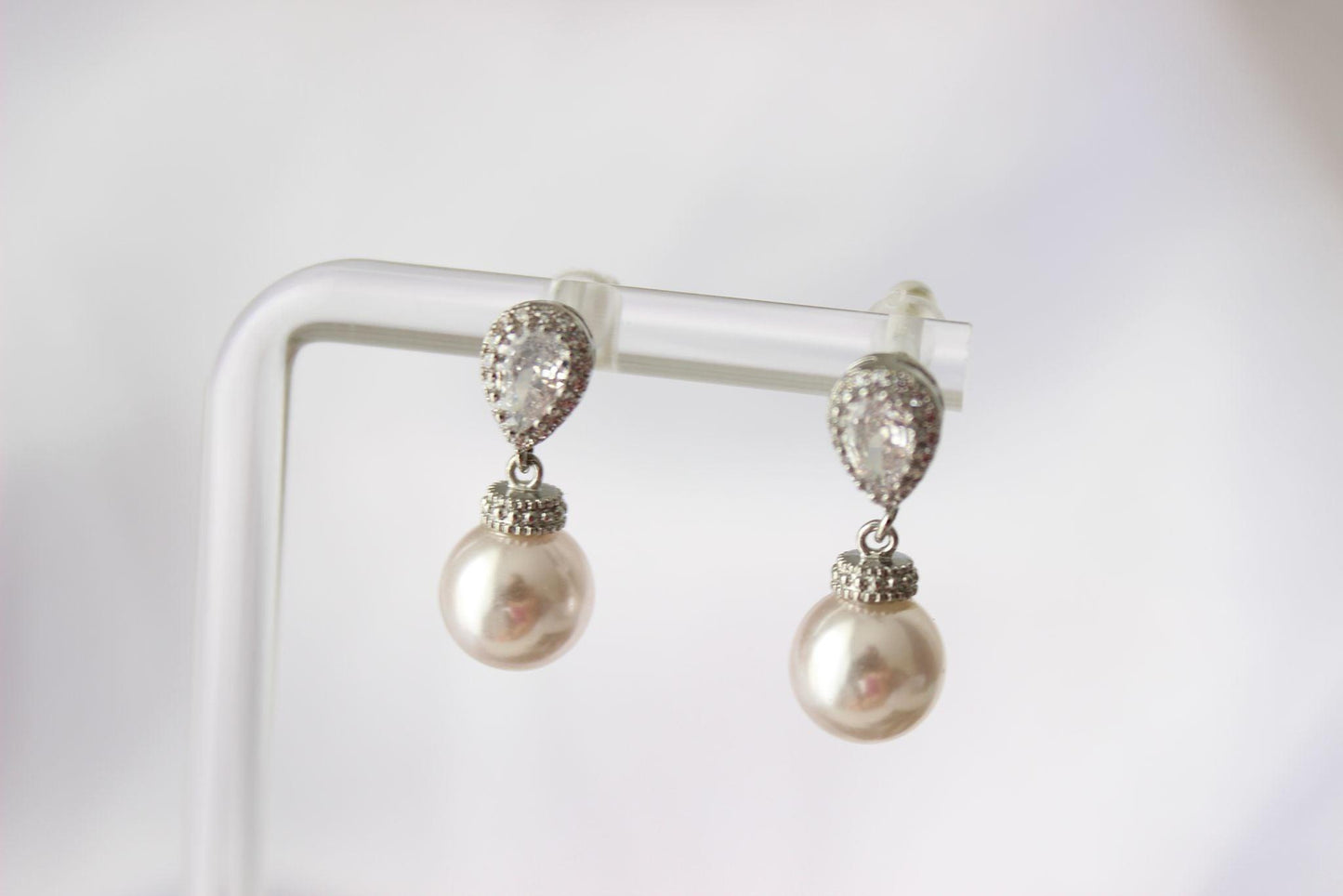 Bianca Mini Light Pink Pearl Drop Bridal Earrings on earring stand