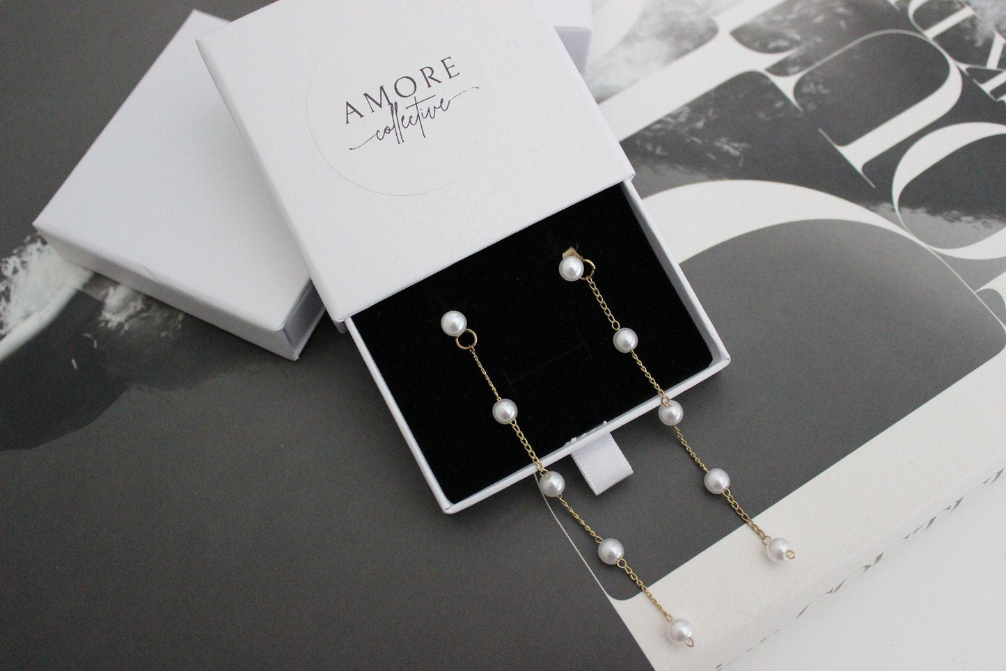 diana pearl gold drop earrings displayed in jewellery box