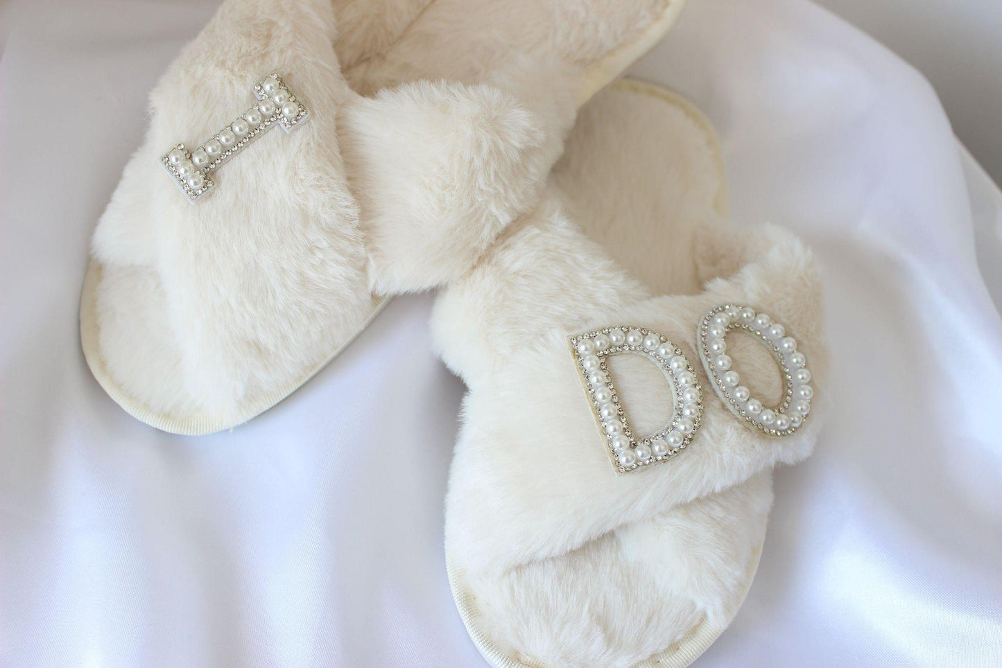 Embellished "I Do" bridal slippers on white cloth