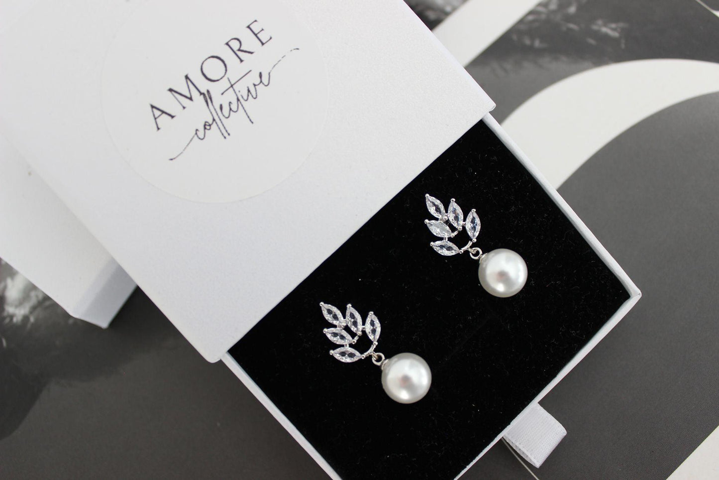 jessica pearl drop silver earrings with leaf design at top and pearl hanging below
