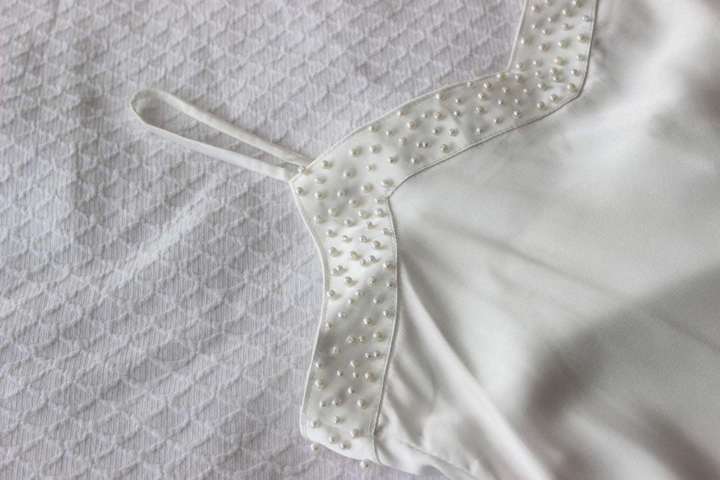 Pearl Bridal Slip on white bed sheet