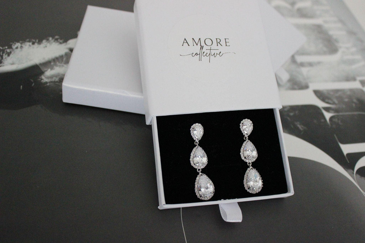 Silver drop earrings with three pear shaped stones