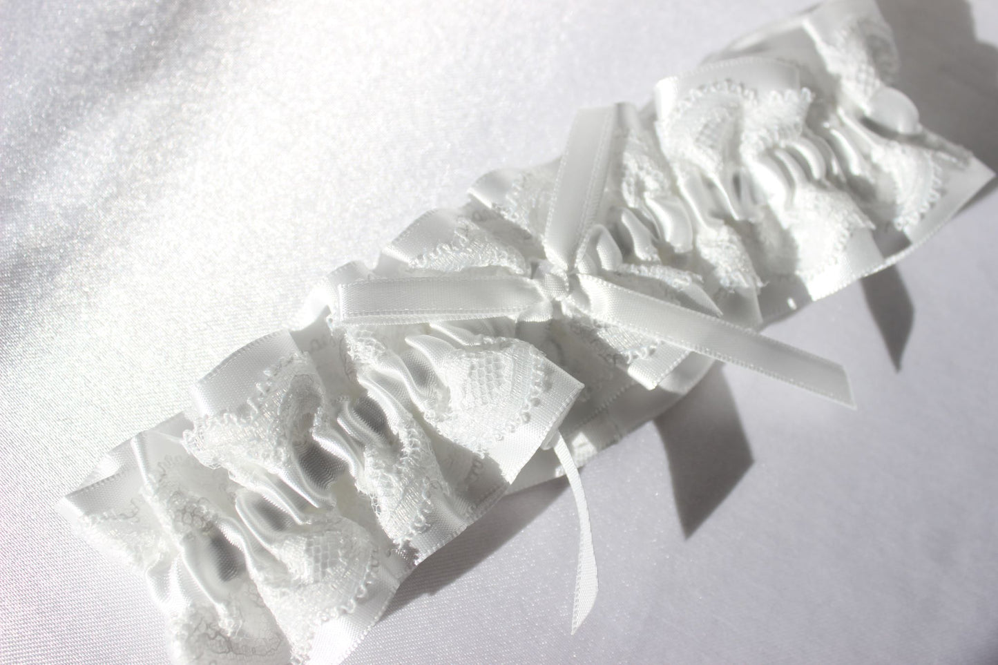 Stella white lace bridal garter with ribbon in centre