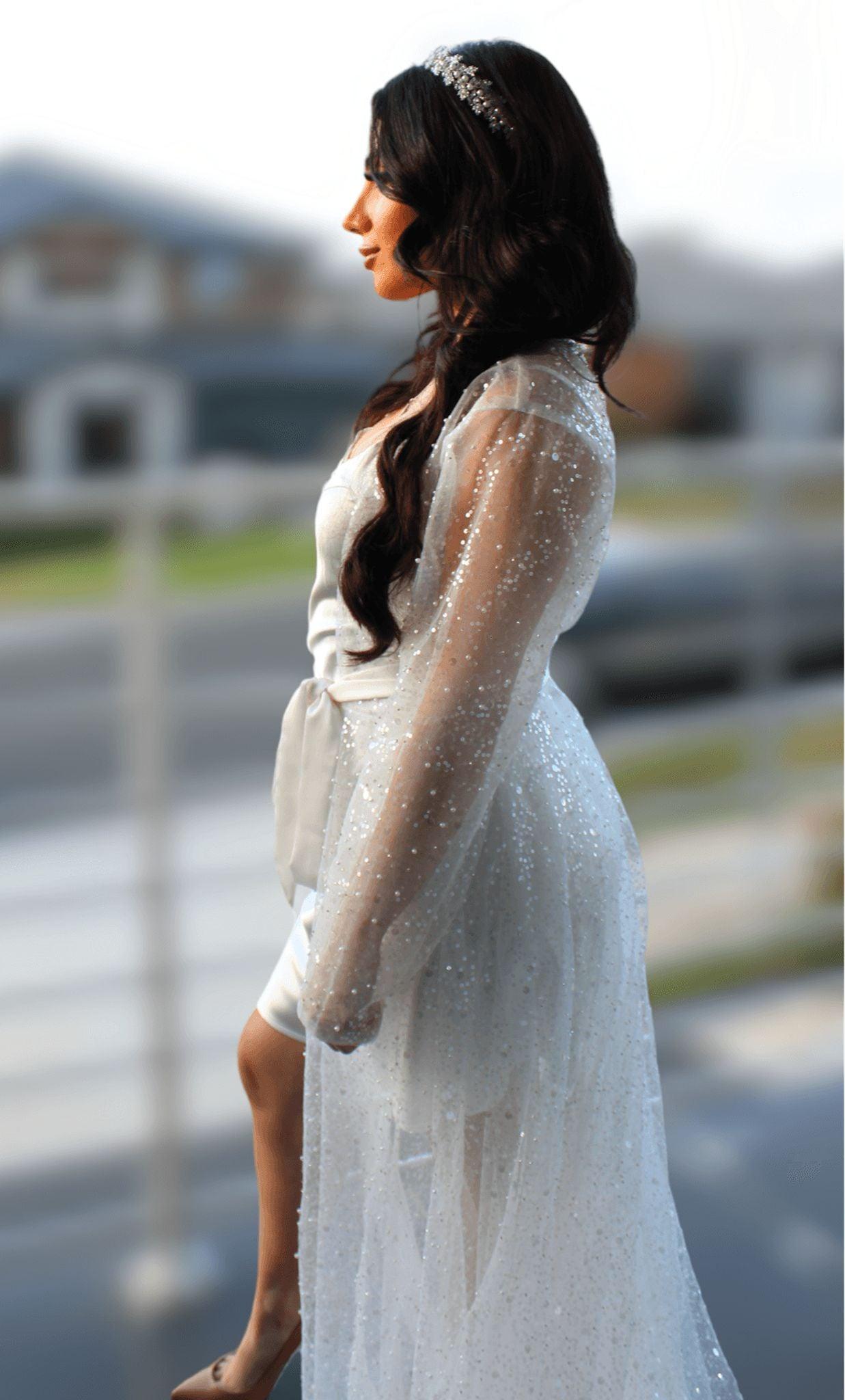 Veronique Sequins Bridal Robe worn by a bride facing sideways on balcony