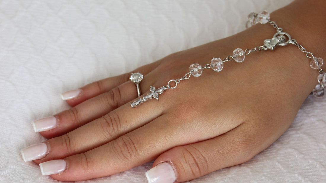 bride wearing rosary bracelet wedding day