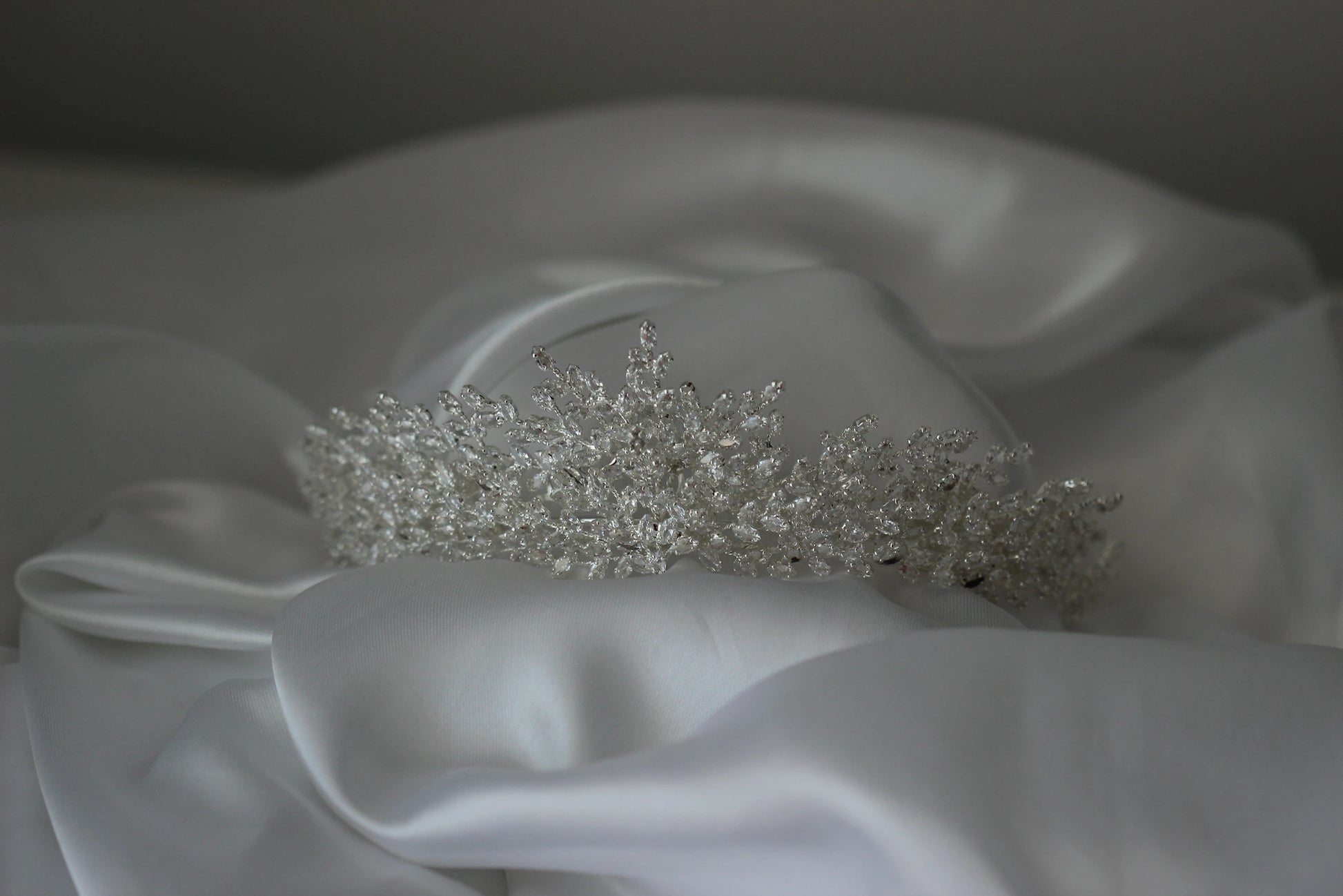 Medium Silver tiara on a white fabric surface