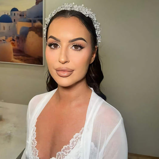 Bride wearing silver bridal headpiece with pearls