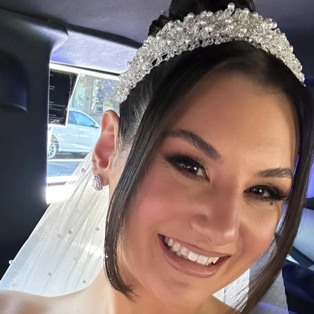 Bride wearing silver bridal headpiece with pearls