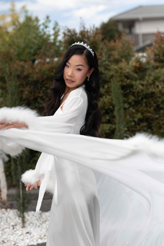 Model wearing fluffy bridal robe and silver bridal tiara