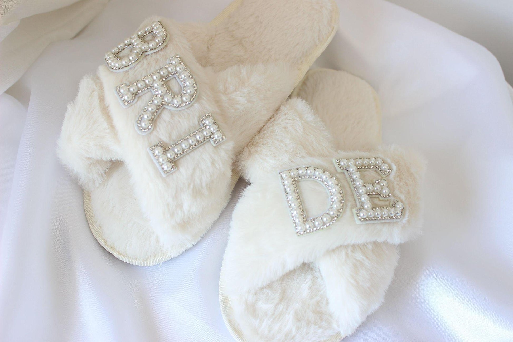 Bridal slippers with "bride" text on white cloth