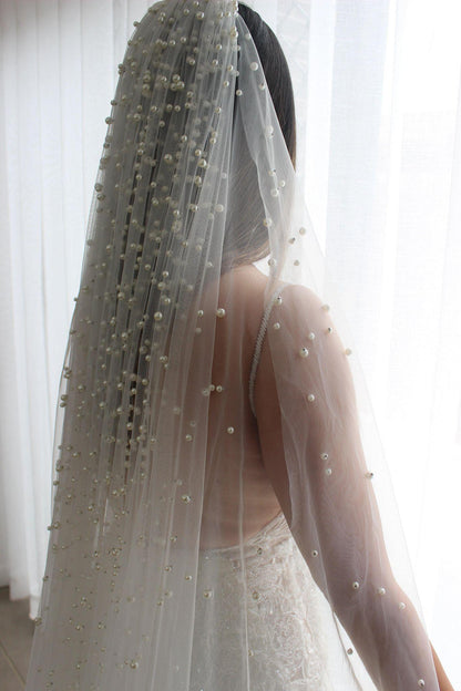 Bride facing away wearing Neveen pearl top 1 tier veil with pearl details