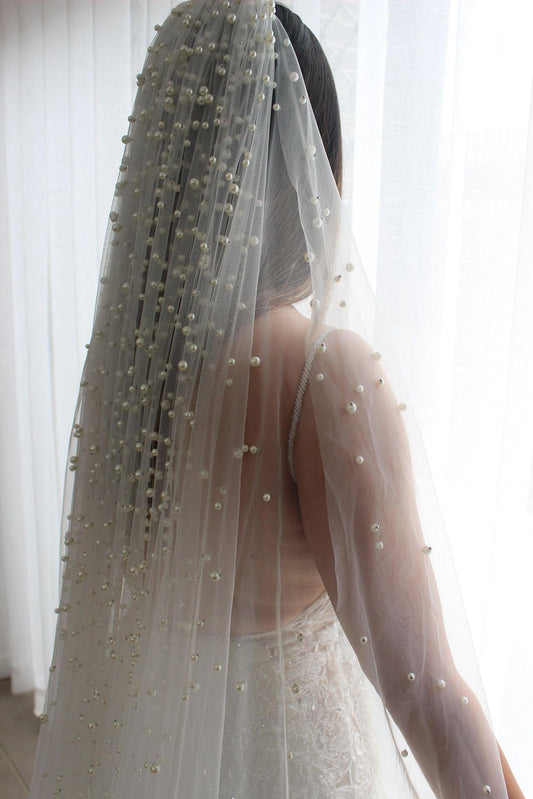 Bride facing away wearing Neveen pearl top 1 tier veil with pearl details