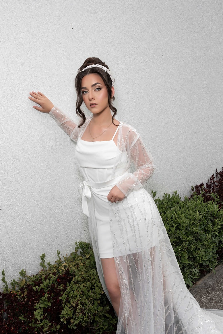 Woman in a bridal robe against a plain background