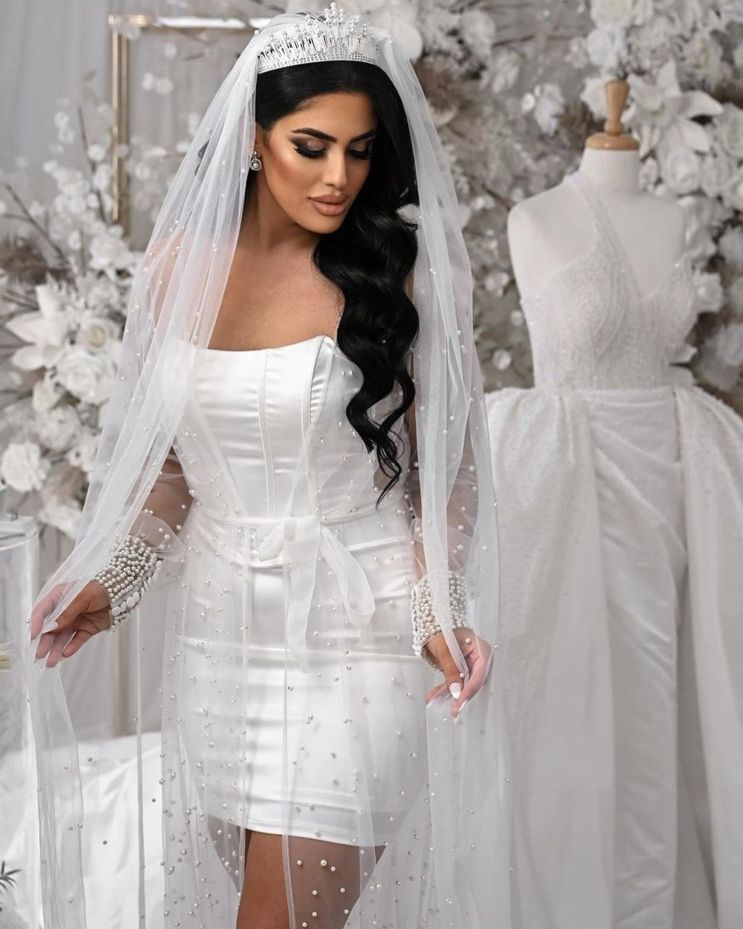 Bride wearing pearl veil, bridal robe and bridal crown