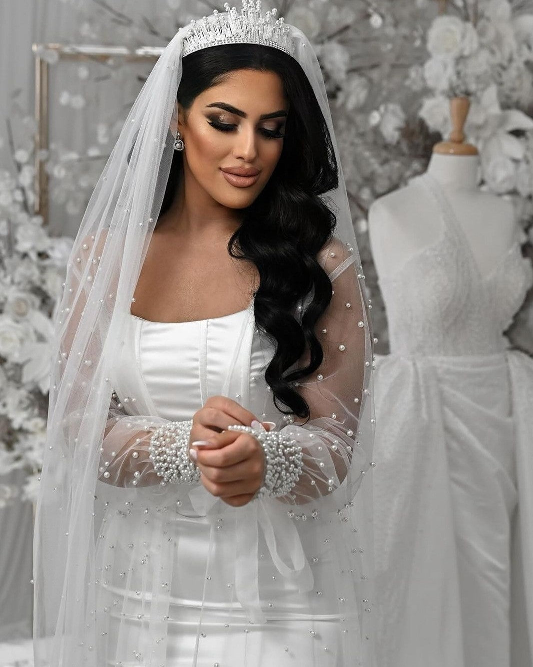 Bride wearing pearl veil, bridal robe and bridal crown