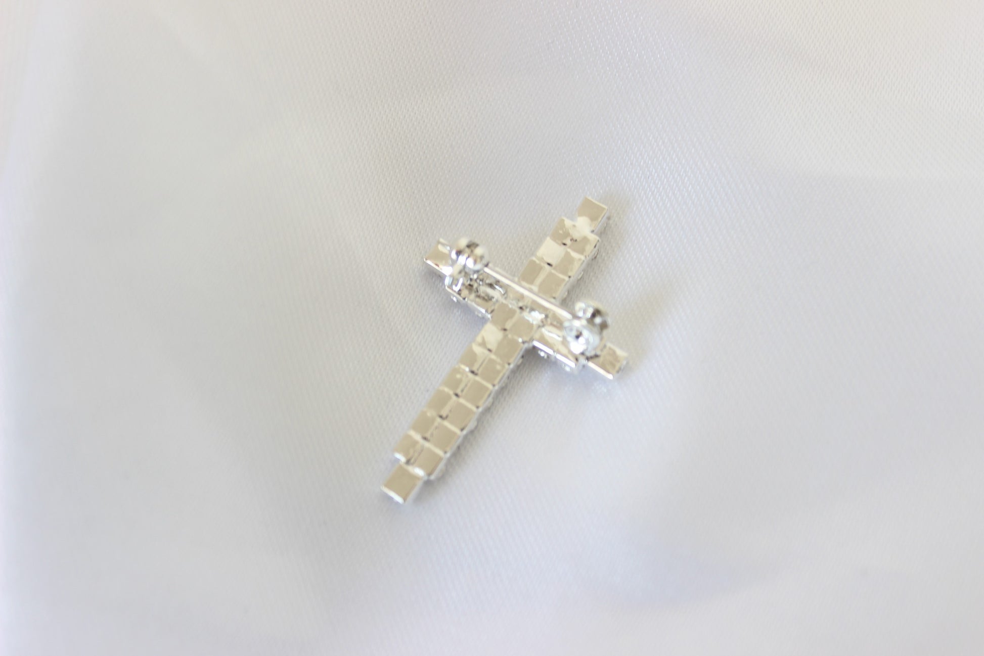 Peter Silver Cross Pin on white cloth