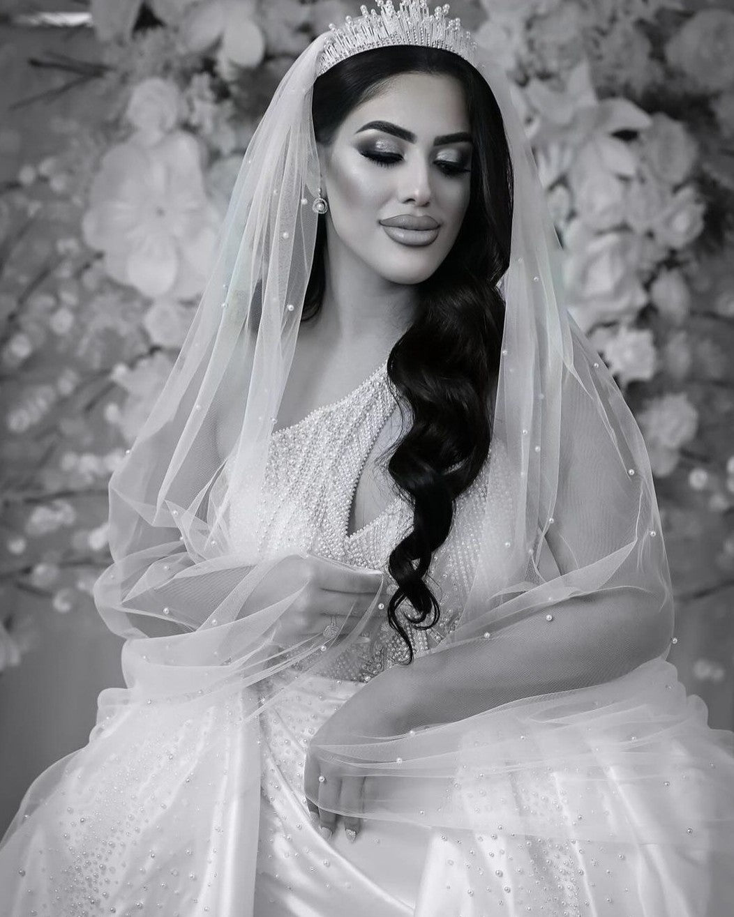 Bride wearing scattered pearl veil and bridal crown