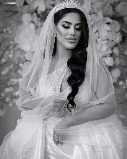 Bride wearing scattered pearl veil and bridal crown