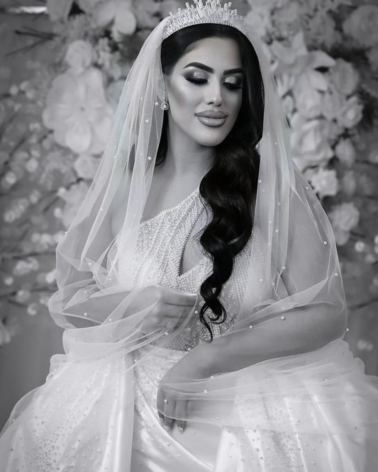Bride wearing scattered pearl veil and bridal crown