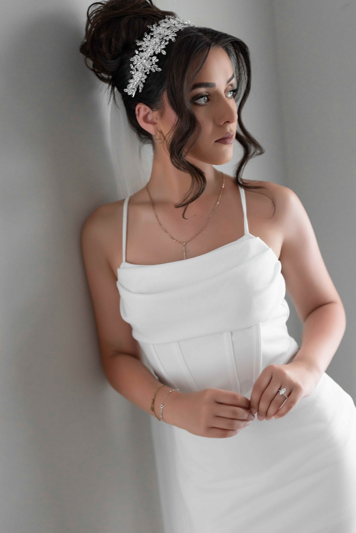Woman in a white bridal slip dress with a neutral background