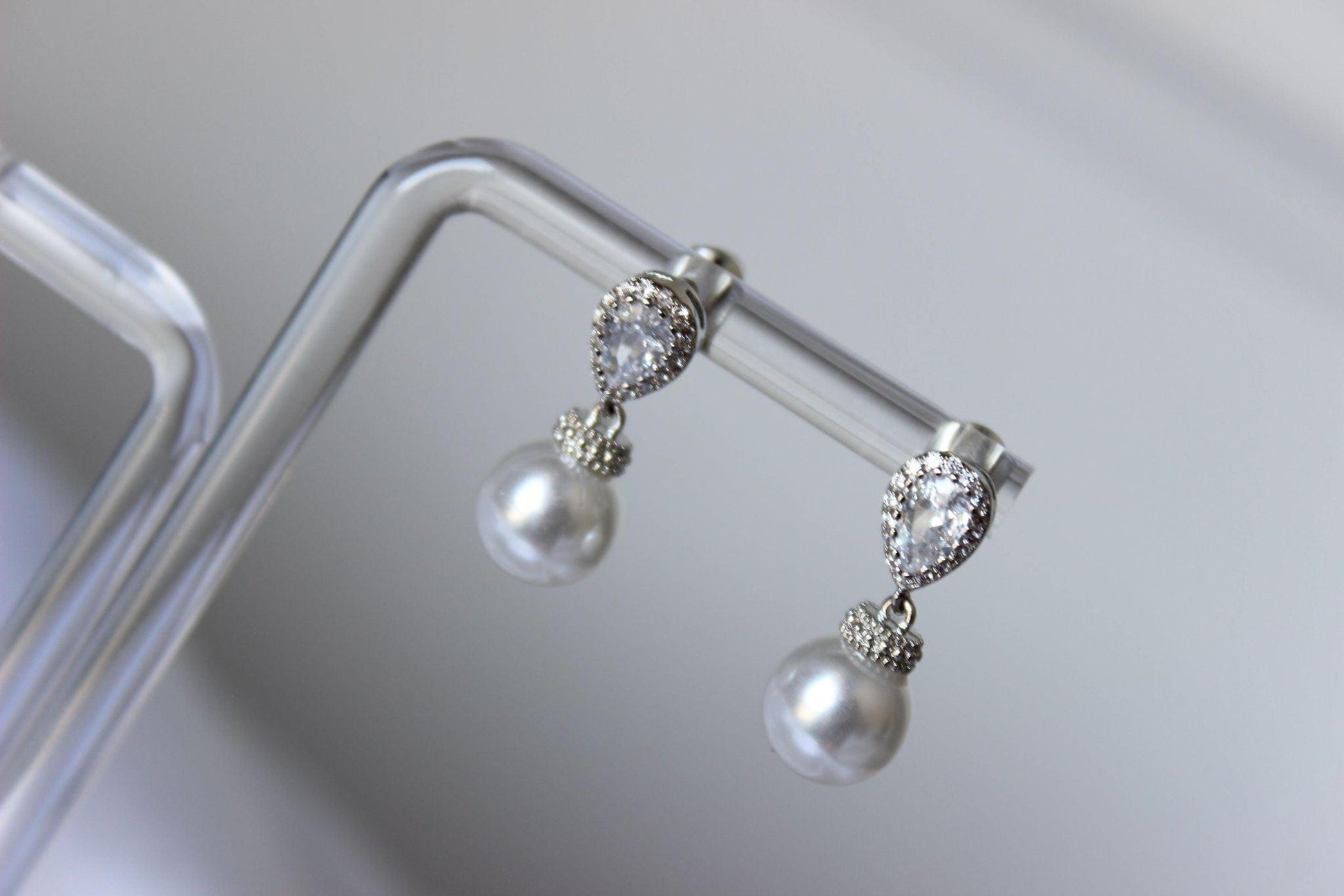 Bianca Mini Pearl Drop Earrings on earring stand