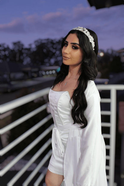 Bride wearing Angel Spliced Sleeve Chiffon gown, leaning on balcony railing