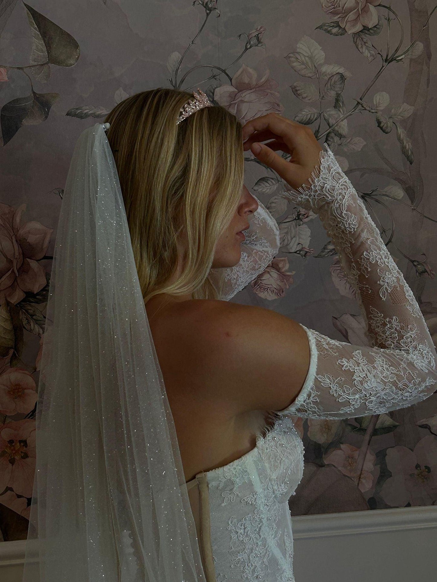 bride posing sideways wearing davina rose gold tiara