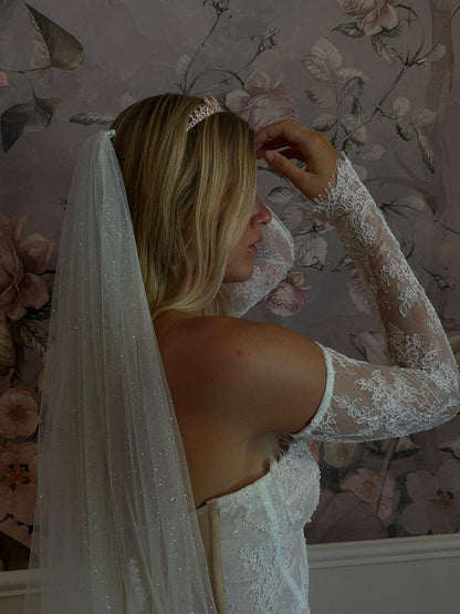 bride posing sideways wearing davina rose gold tiara