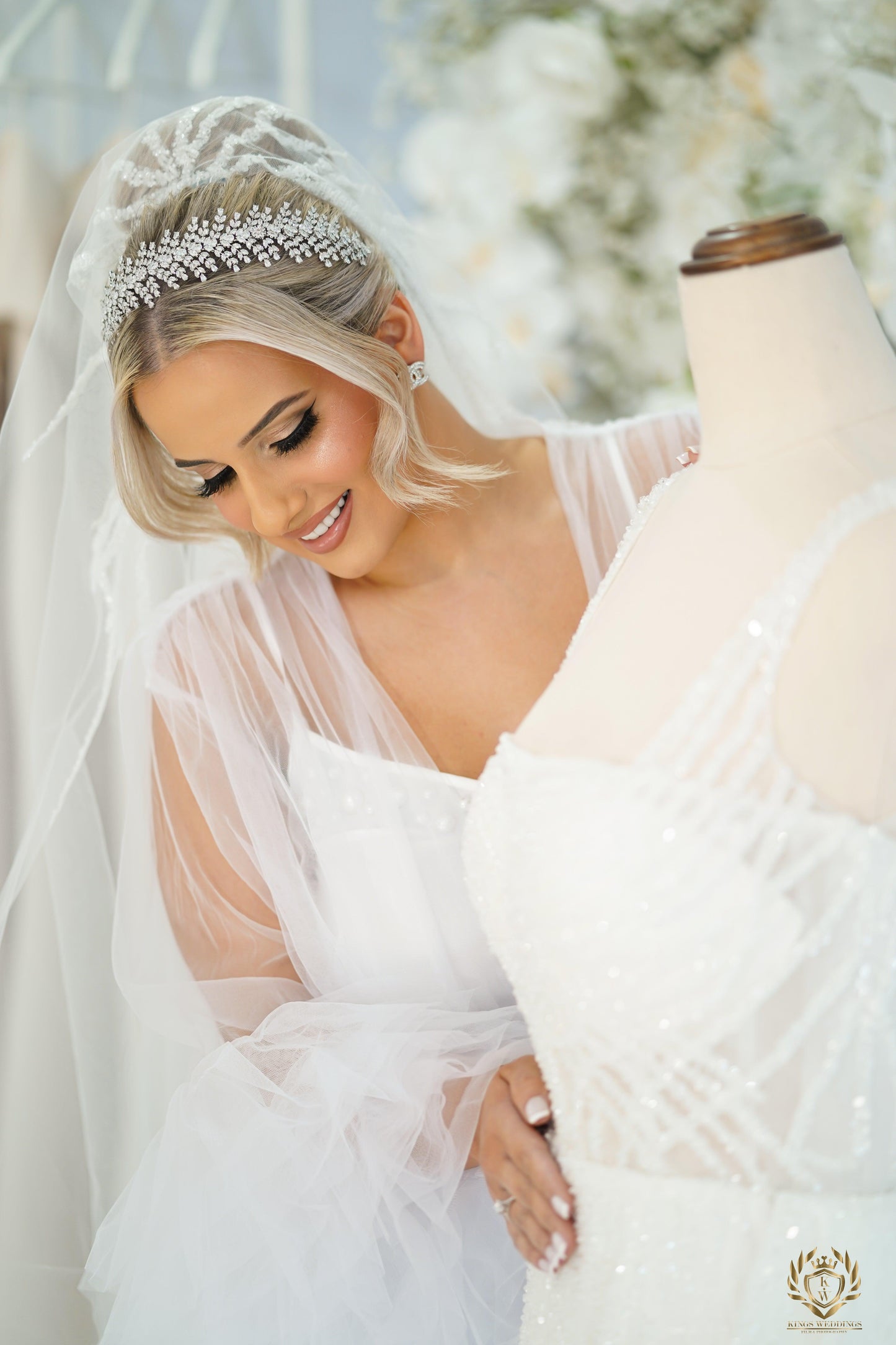 Close-up of Christina bridal headband on mannequin as bride-to-be touches the gown