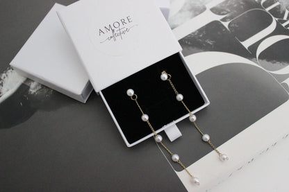 diana pearl gold drop earrings displayed in jewellery box