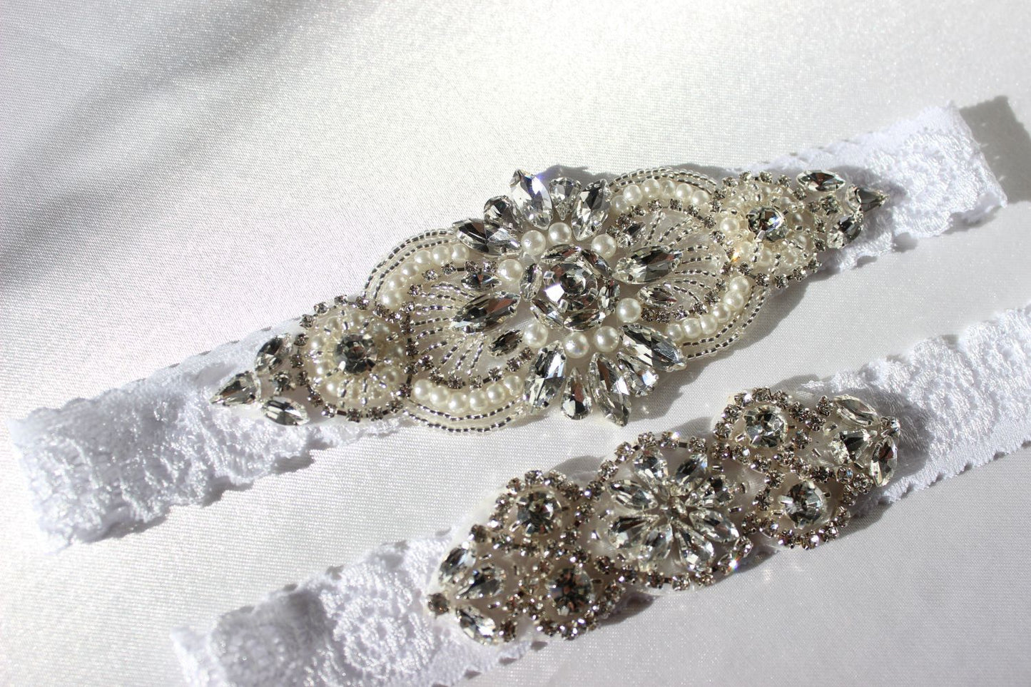 Close up of Freya floral lace bridal garter with pearls and CZ crystal details