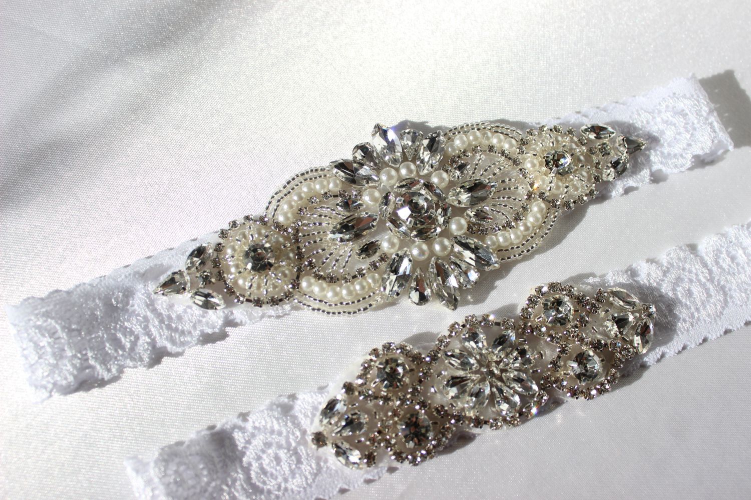 Close up of Freya floral lace bridal garter with pearls and CZ crystal details