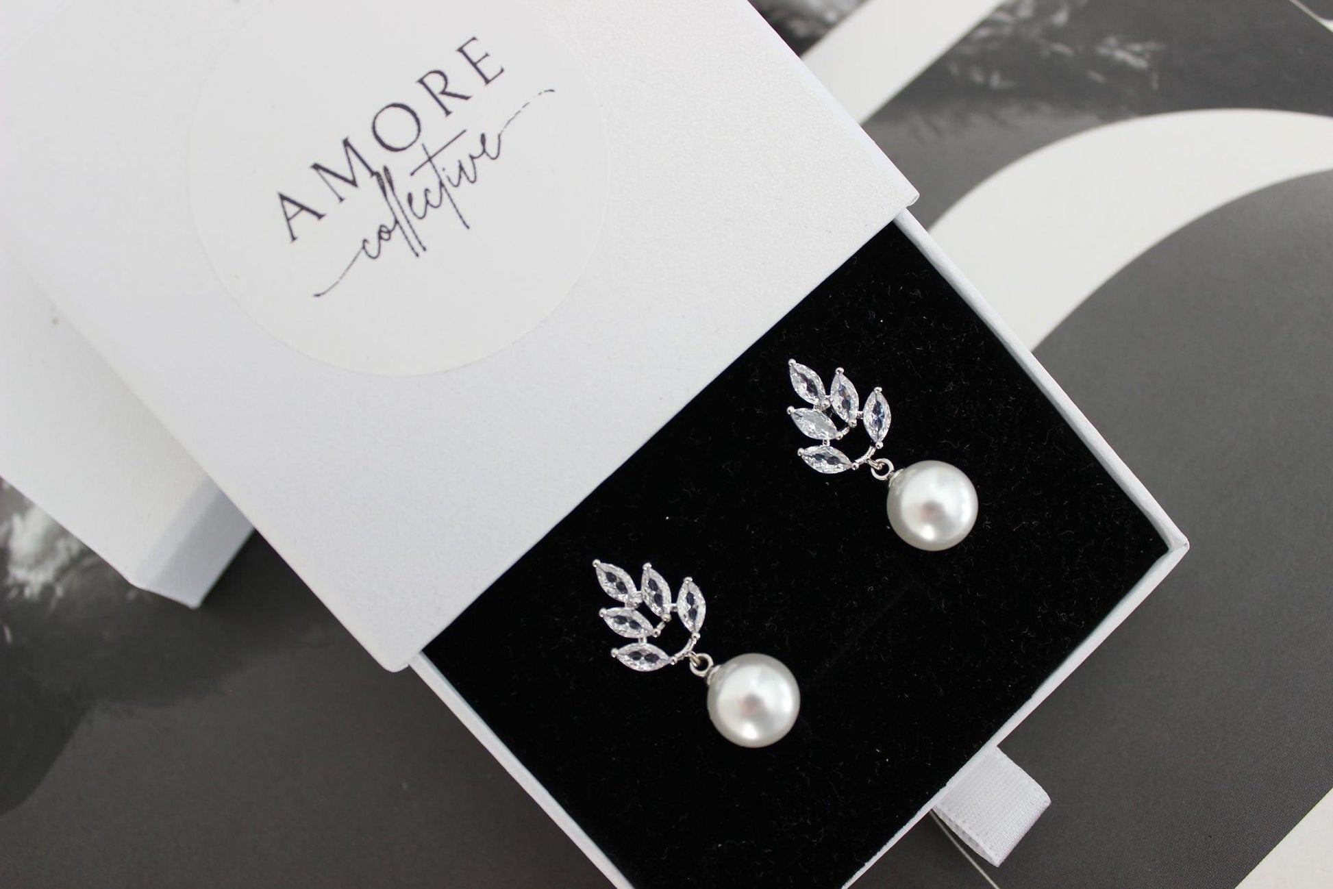 jessica pearl drop silver earrings with leaf design at top and pearl hanging below