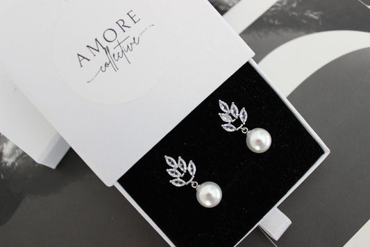 jessica pearl drop silver earrings with leaf design at top and pearl hanging below