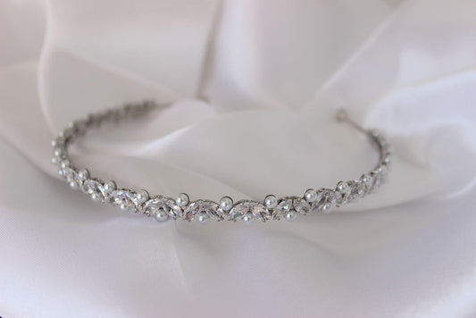 Jordyn silver bridal headband with cubic zirconia and pearls on white cloth