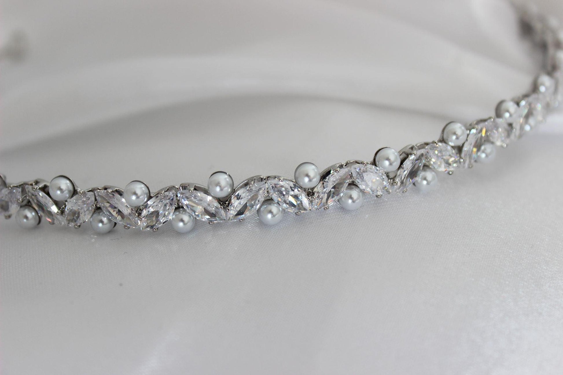Jordyn crystal and pearl silver bridal headband on white cloth