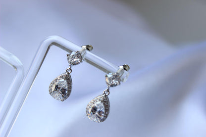 Karmela pear-shaped cubic zirconia silver drop earrings on earring stand