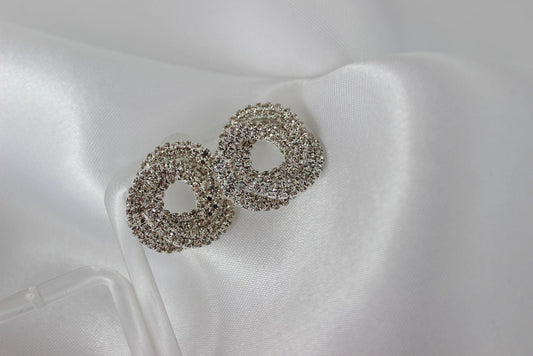 Large bridal swirl silver bridesmaid earrings on white cloth