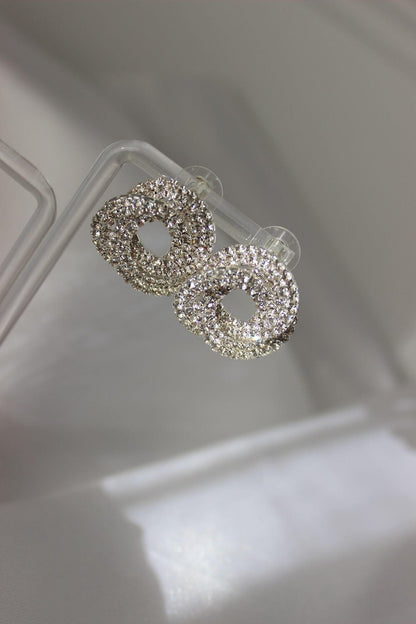 Large bridal swirl silver bridesmaid earrings on earring stand