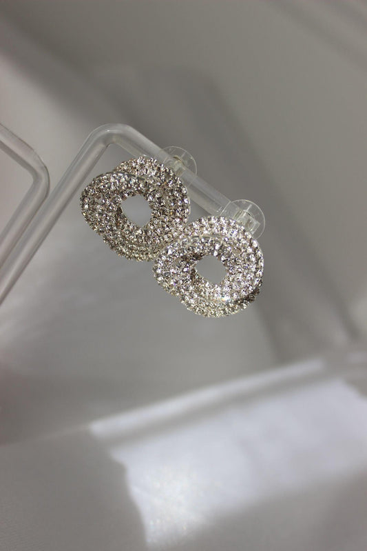 Large bridal swirl silver bridesmaid earrings on earring stand