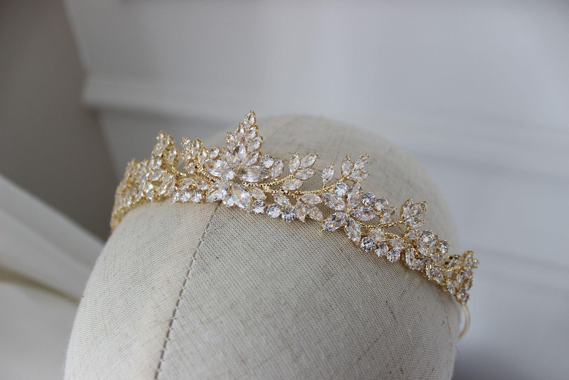Close up of Swarovski crystal detailing on gold bridal tiara