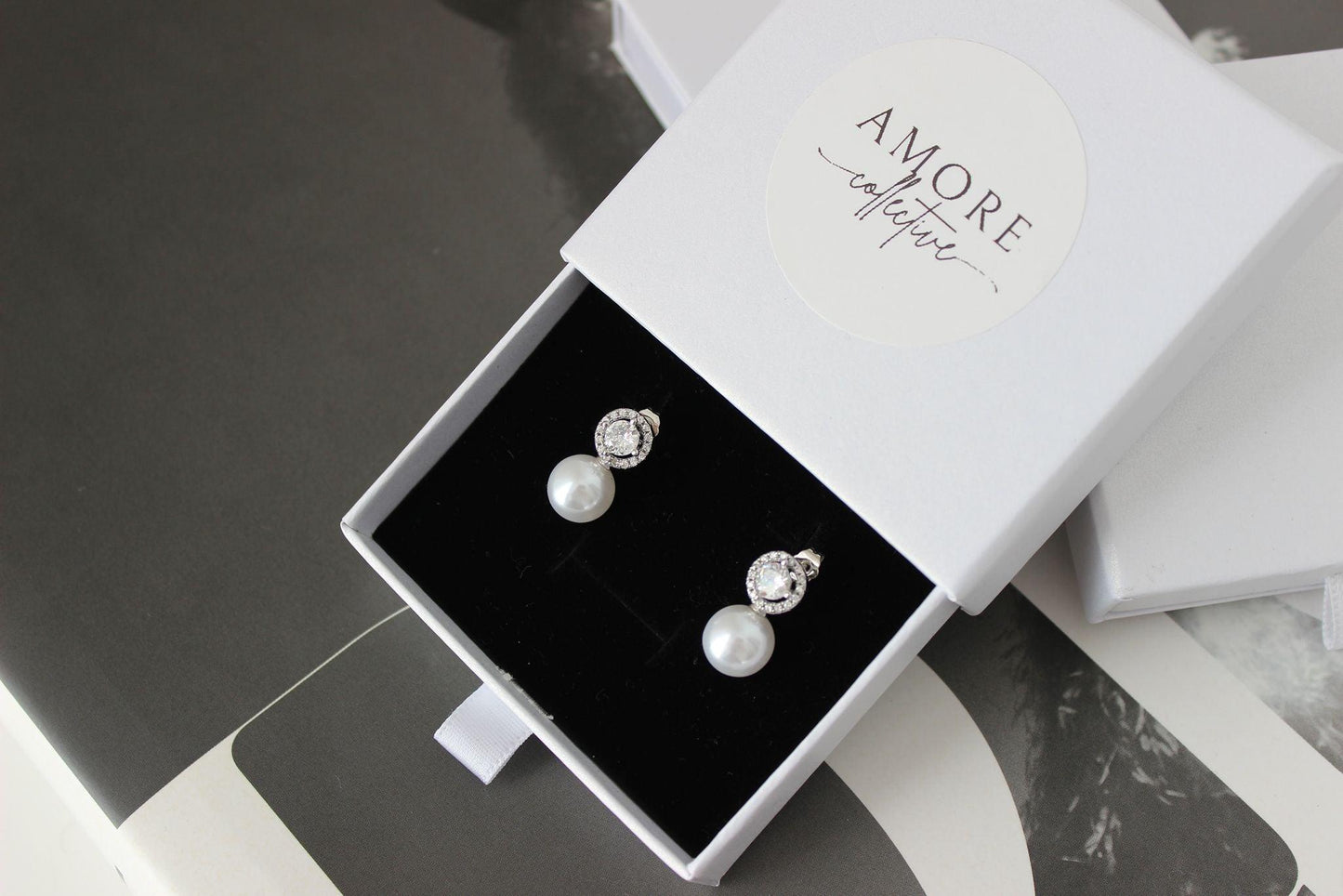 pearl drop silver earrings with cubic zirconia round stone on top