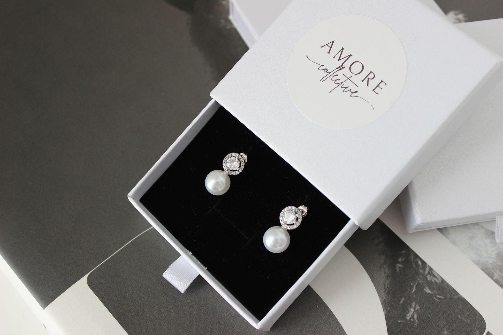 pearl drop silver earrings with cubic zirconia round stone on top